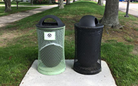 black trash bin and green recycling bin